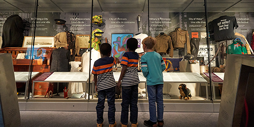3 children looking at a museum exhibit