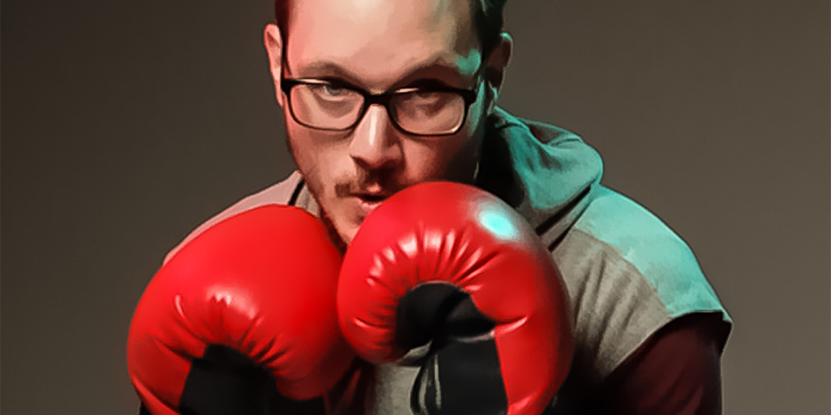 Scott Graceffo looking into the camera in a boxing stance.