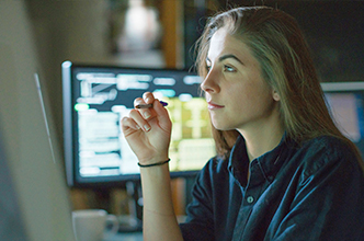 Woman looking at a computer monitor