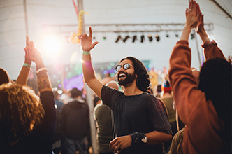Man waving at an outdoor concert