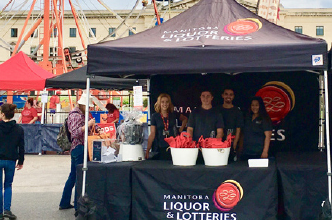 MBLL Employees standing under an event tent